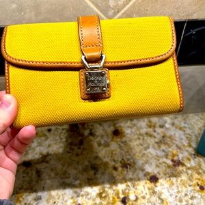Authentic Dooney & Bourke wallet. Used. Small stain on back. Clasp works.Leather